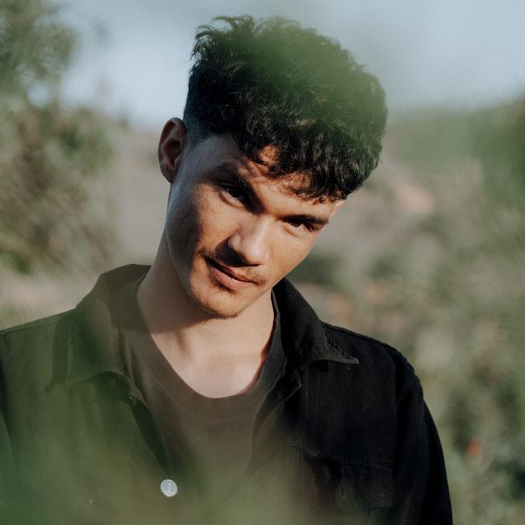 Avery Singh, Lead Design Curator at LunarFieldTrack, reviewing corporate floral arrangements